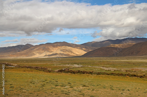 View of the mountains and dramatic sky near Tingri on the way to Everest Base Camp, Tibet, China