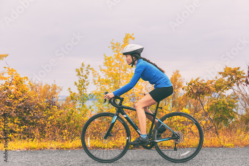 Bike cyclist outdoor woman biking road bicycle in autumn foliage nature.