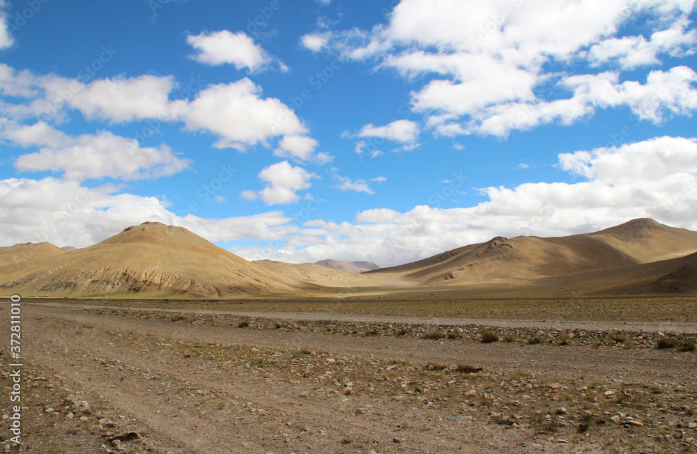 View of the mountains and dramatic sky near Tingri on the way to Everest Base Camp, Tibet, China