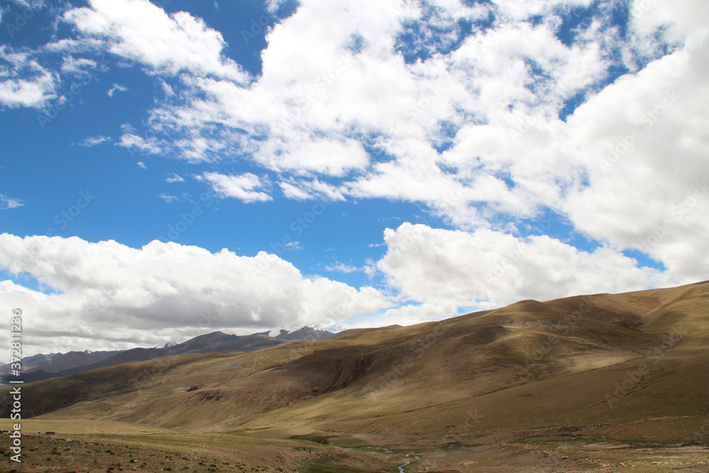 View of the mountains and dramatic sky near Tingri on the way to Everest Base Camp, Tibet, China View of the mountains and dramatic sky near Tingri on the way to Everest Base Camp, Tibet, China