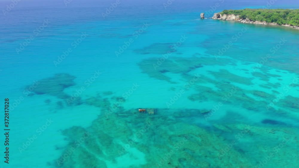 Sunken Cargo Shipwreck, Barco Hundido, A Popular Diving Spot Sits in the Fantastic Clear Blue Waters of Las Galeras with Tropical Backdrop in the Dominican Republic, Drone Aerial Sunken Cargo Shipwreck, Barco Hundido, A Popular Diving Spot Sits in the Fantastic Clear Blue Waters of Las Galeras with Tropical Backdrop in the Dominican Republic, Drone Aerial