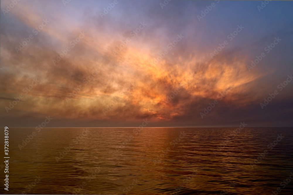 Sea sunset. Smoke wildfires sweeping across the sky.