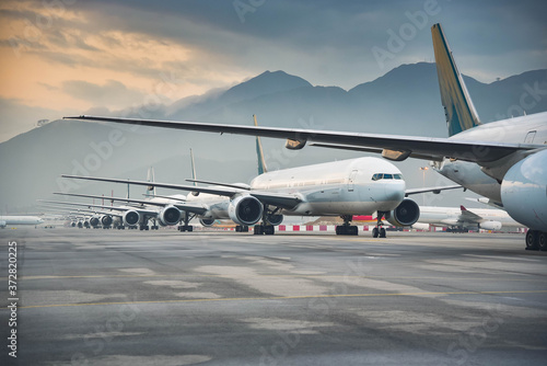 Due to Coronavirus Covid-19 airline fleet parked at the taxiway of Airport 