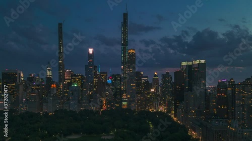 AERIAL HYPERLAPSE: Day to Night Motion Timelapse of New York from Central Park with beautiful city lights.