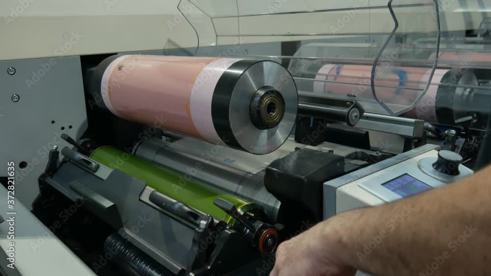 Printing machine where a roll is raised where the rubber template is placed for only one ink-man working with printing industry machine Printing machine where a roll is raised where the rubber template is placed for only one ink-man working with printing industry machine