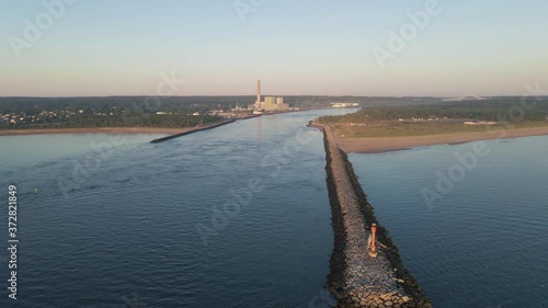 aerial view of ocean pier alongside canal with factory and bridge photo