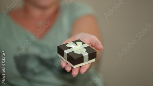 Wallpaper Mural woman holding gift box in hand Torontodigital.ca