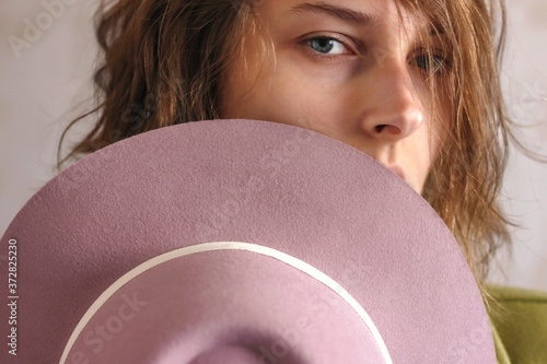 Konstfotografi Girl with a pink hat. Young woman model. Close-up photo