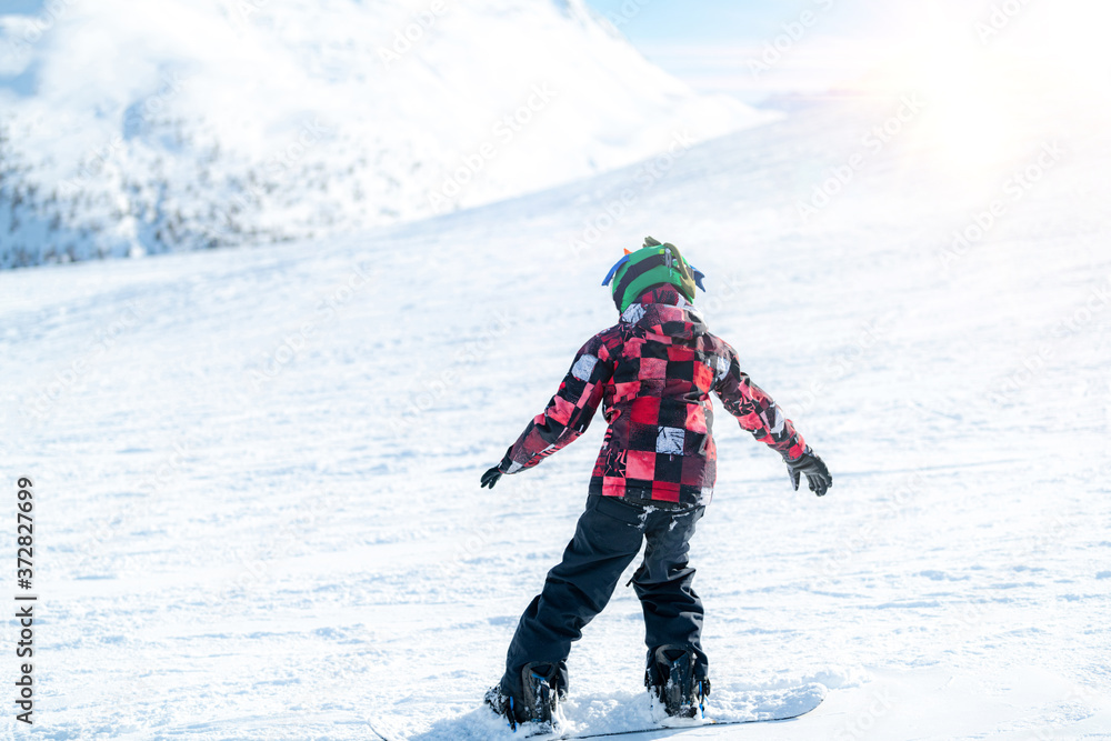 Cute Boy Snowboarding Down the Slope Cute Boy Snowboarding Down the Slope