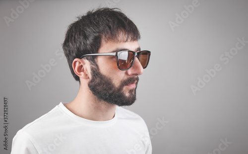Caucasian man wearing sunglasses in studio. © andranik123