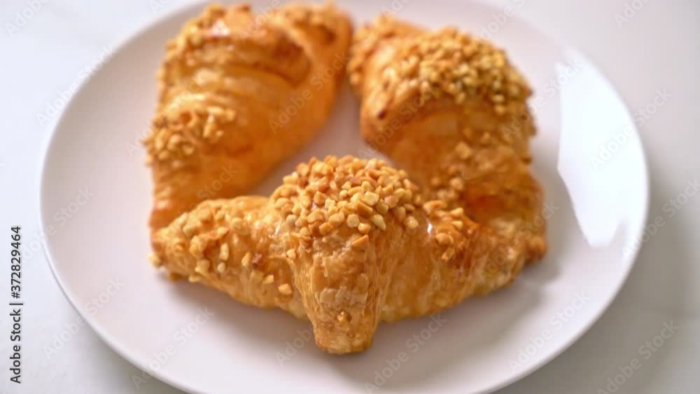 fresh croissant with peanut on plate fresh croissant with peanut on plate