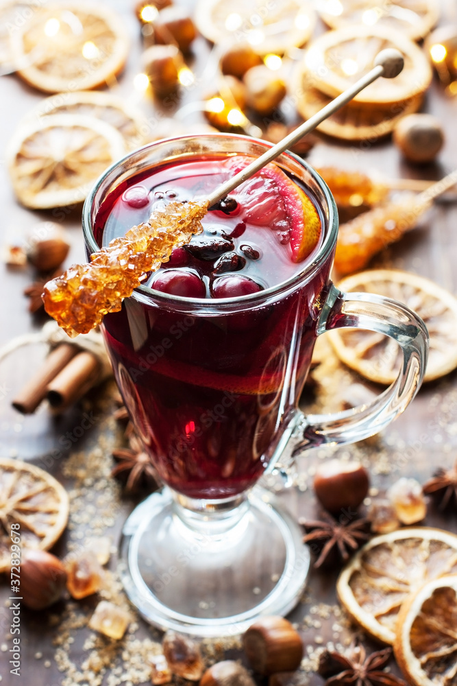 Mulled wine with orange and spices in glass mug Mulled wine with orange and spices in glass mug