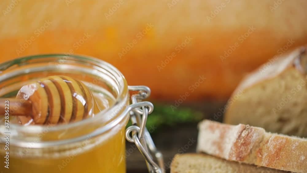 organic honey and rustic bread on a old wooden table. Healthy eating breakfast.
