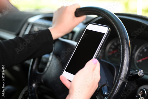 Woman using mobile phone while driving a vehicle © Rafael Ben-Ari