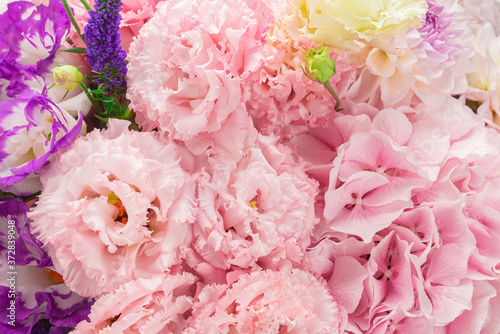 Pink and purple bouquet of flowers in a pink box isolated on white.