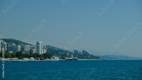 Panorama of the coast of Sochi in summer. Large-format. Black Sea, Russia. View from the sea. No people. Sunny day. Modern city on the beach. © Ivan_vislov_nadsochi