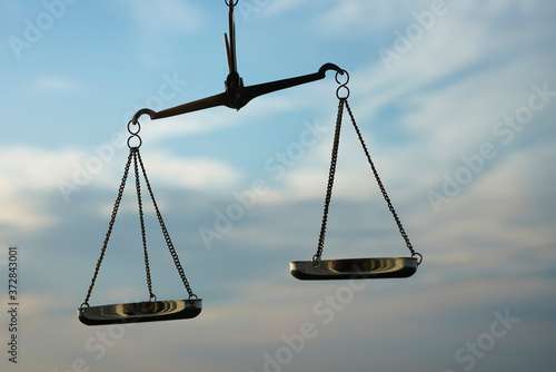 Scales of Justice background - legal law concept. a balance is hand-held, sky is the background.zodiac sign - libra