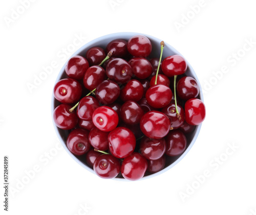 Sweet juicy cherries in bowl isolated on white, top view
