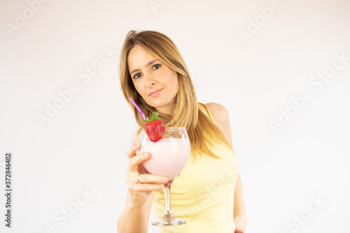 Pretty woman drinking having a strawberry smoothie