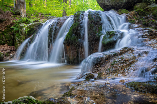 Long exposure of stream waterfalls in summer forest © Jaroslav Machacek