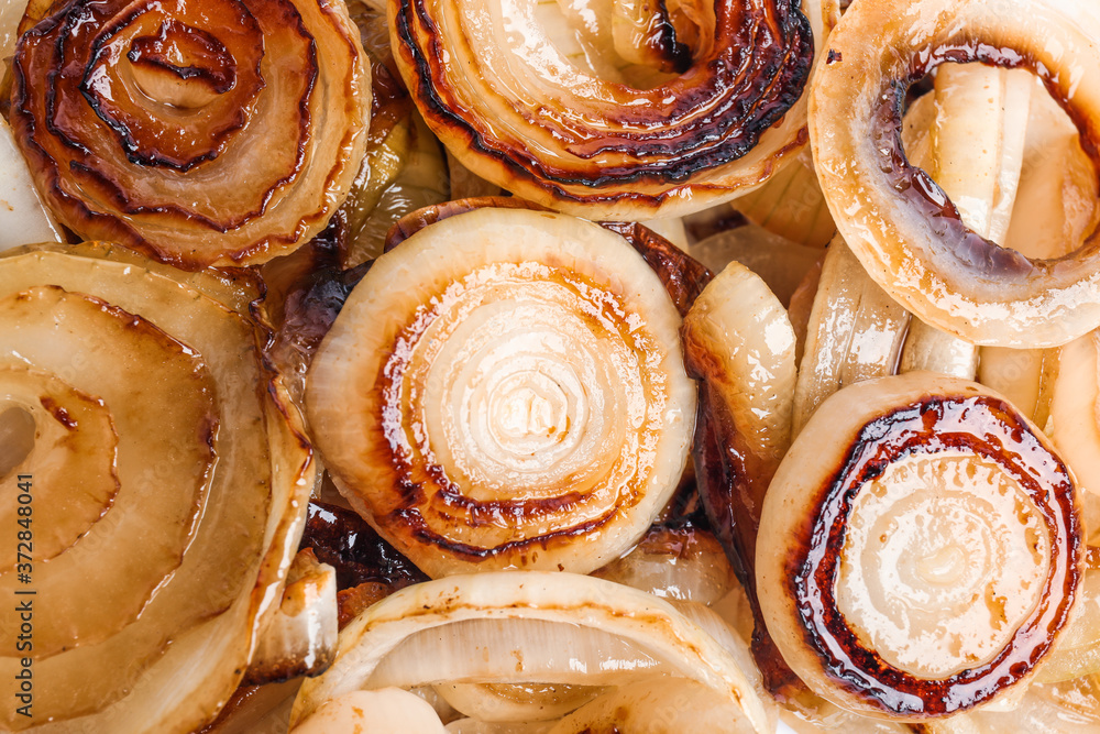 Fototapeta premium Tasty fried onion as background, top view