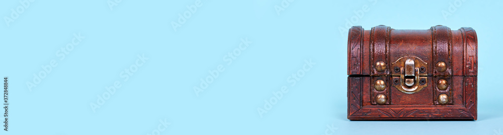 Wooden chest decoration, home casket, isolated on blue background, copy space template, banner. Wooden chest decoration, home casket, isolated on blue background, copy space template, banner.