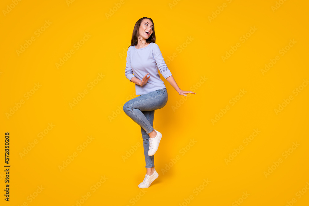 Full length body size view of her she nice attractive carefree cheerful cheery girl jumping having fun dancing cozy comfort clothes wear isolated bright vivid shine vibrant yellow color background Full length body size view of her she nice attractive carefree cheerful cheery girl jumping having fun dancing cozy comfort clothes wear isolated bright vivid shine vibrant yellow color background
