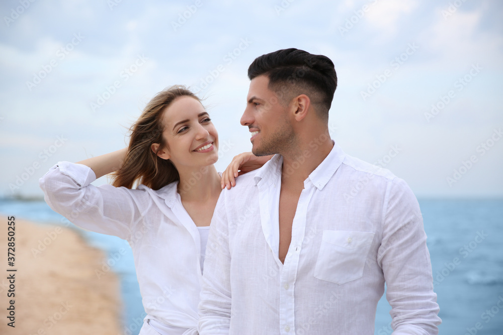 Happy couple having romantic walk on beach Happy couple having romantic walk on beach