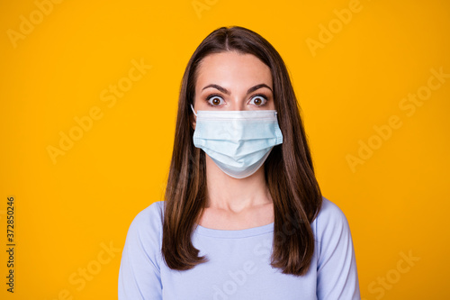 Close-up portrait of her she attractive pretty stunned worried brown-haired girl wearing safety mask stop flu flue gripe contamination isolated bright vivid shine vibrant yellow color background
