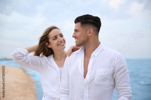 Happy couple having romantic walk on beach
