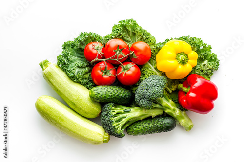 A tabletop arrangement of fresh vegetables multicolored  top view