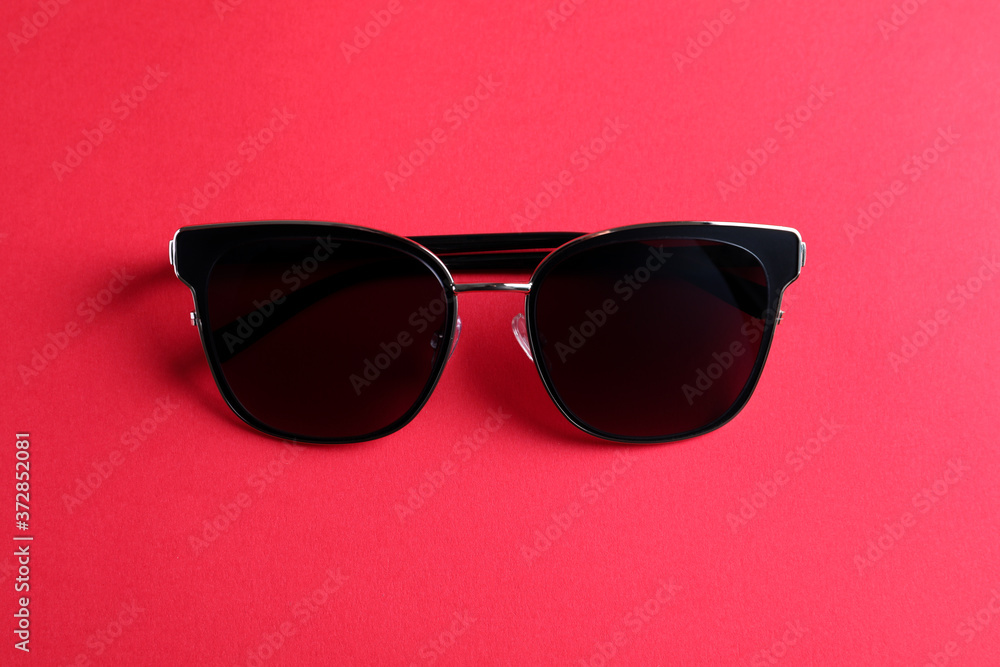 Stylish sunglasses on pink background, top view Stylish sunglasses on pink background, top view