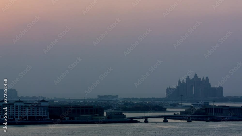 Striking sunset visual of Palm Jumeirah as the camera zooms into Atlantis The Palm hotel putting it into a beautiful frame, Aerial, 6-axis stabilized gimbal, Shotover F1, 8K, parallax. Striking sunset visual of Palm Jumeirah as the camera zooms into Atlantis The Palm hotel putting it into a beautiful frame, Aerial, 6-axis stabilized gimbal, Shotover F1, 8K, parallax.