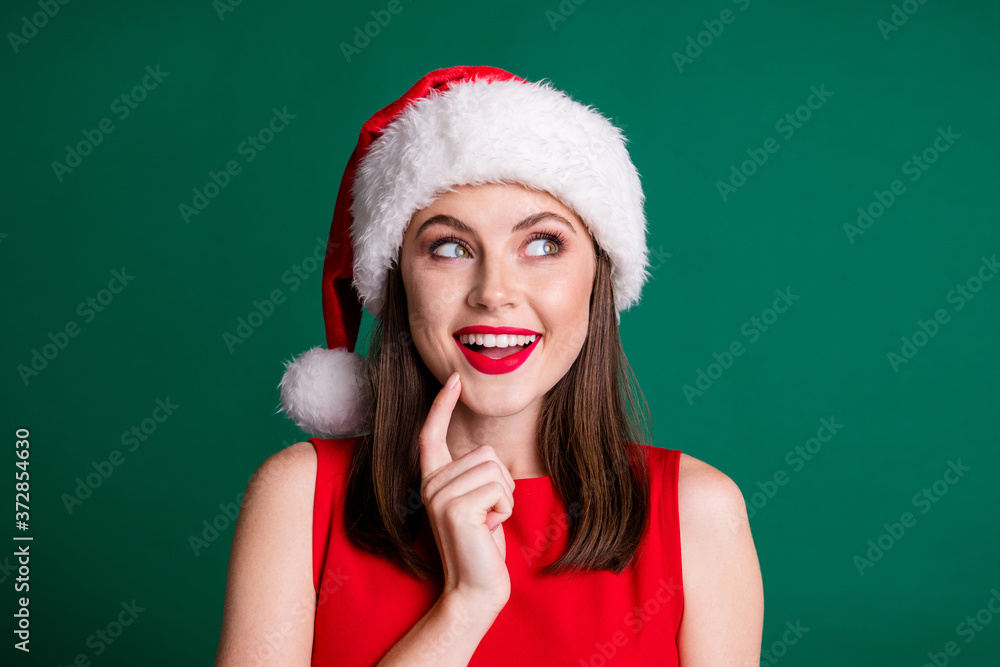 Closeup photo of attractive charming x-mas party lady look side up empty space arm chin dreamer wait miracle magic fireworks watch sky wear santa cap isolated green pastel color background Closeup photo of attractive charming x-mas party lady look side up empty space arm chin dreamer wait miracle magic fireworks watch sky wear santa cap isolated green pastel color background