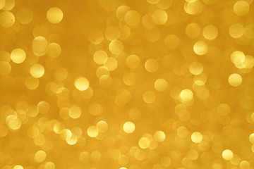gold Sparkling Lights Festive background with texture. Abstract Christmas twinkled bright bokeh defocused and Falling stars. Winter Card or invitation	
