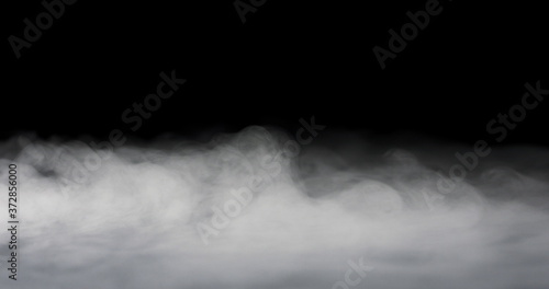 heavy fog passing across a black background.