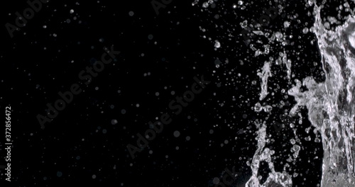 water splashing up from the right side of the frame against a black background.