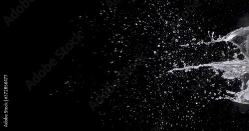 burst of water coming from the right side of the black background.