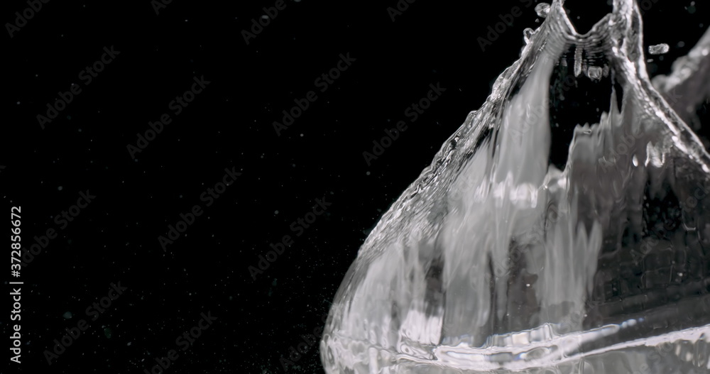 water being thrown against a black background.