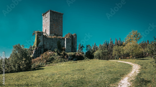 Beautiful shot of an old tower castle of the Andrade in the eume woods on a blue sky background photo