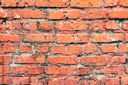 Weathered texture of stained old dark white and orange brick wall background © chernikovatv