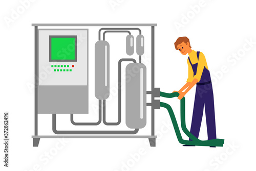 Man using wine making equipment - steel distillery tank with control panel