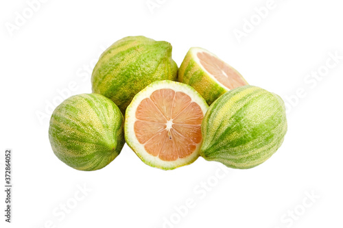 Heap of Pink lemons isolated on white background. Citrus fruit with striped rind. Lemon cut in half with pink flesh photo