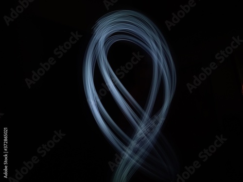 light painting Photography, long exposure, ripple curve and circle against black background