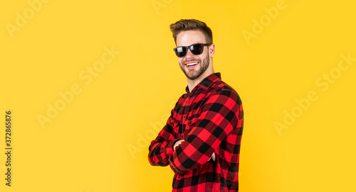 Loving new style. handsome man in sunglasses. indoor portrait of sexy european businessman. confident and calm. handsome casual man standing with beard and bristle. cheerful and stylish. copy space