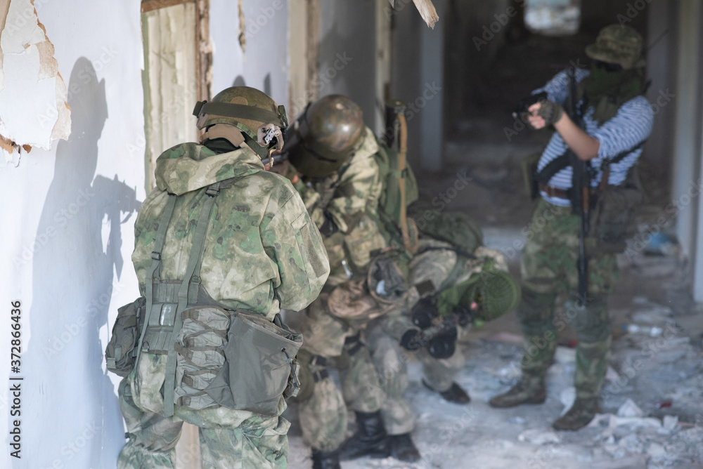 Fototapeta premium A team of professional airsoft players clear the location from opponents