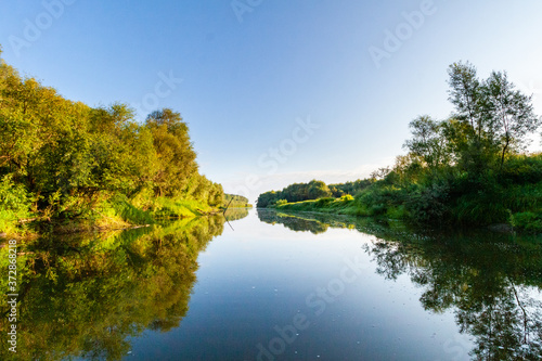 Siberian River Ob surrounded by Trees in Early morning in Russia in sunny weather during summer