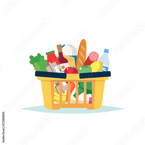 Supermarket grocery basket full of different groceries