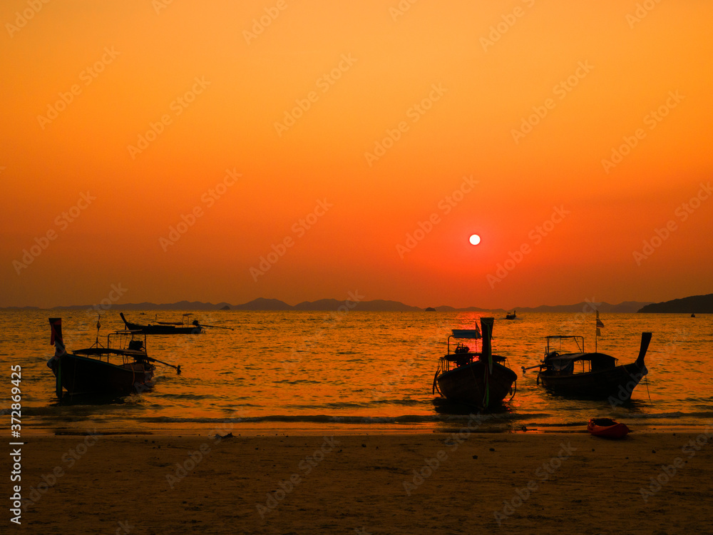 Longtail boats in West Railay beach at sunset. Krabi, Thailand