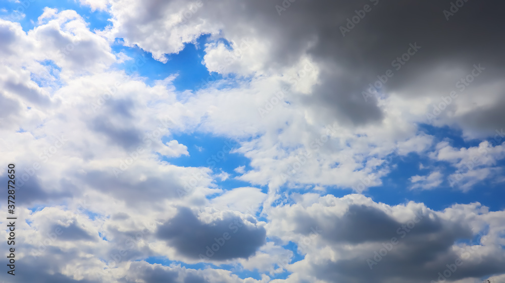 Fototapeta premium Weather dark gray clouds on blue sky close-up